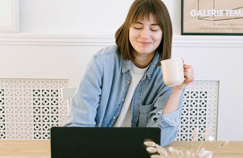 Woman working on a laptop with coffee