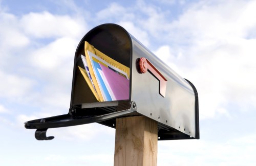 Image of a mailbox with mail in it.