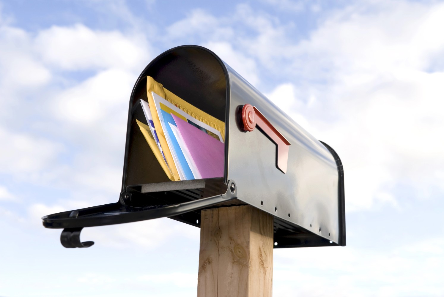 Image of a mailbox with mail in it.